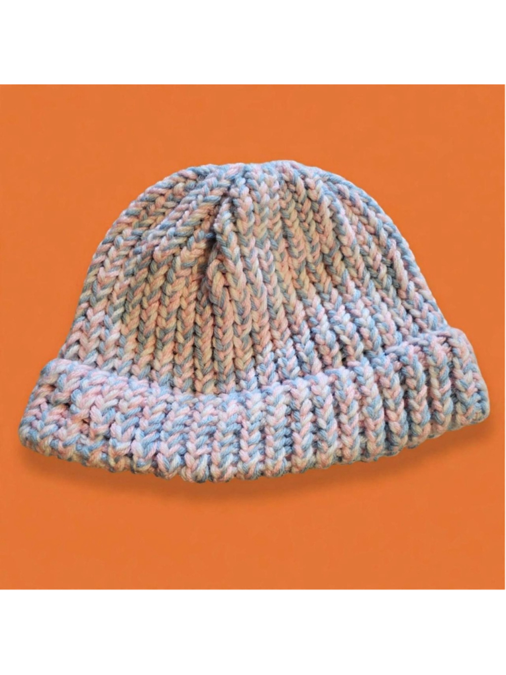Handmade knit hat in pink, blue, and gray